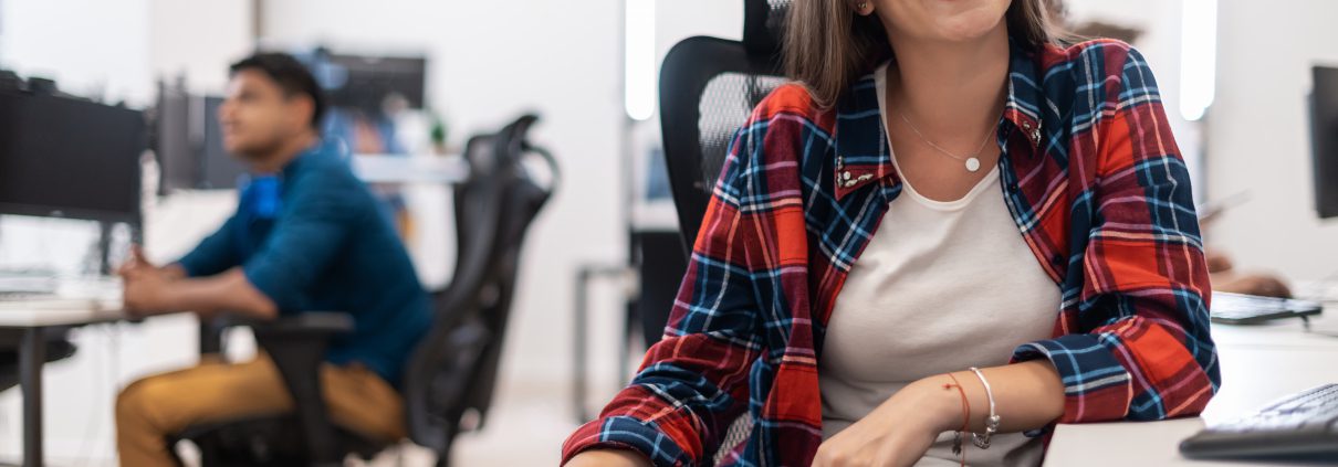 business woman working on desktop computer in modern open plan office