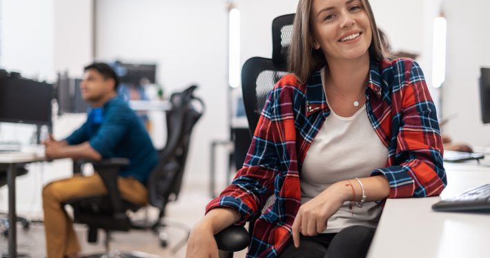 business woman working on desktop computer in modern open plan office